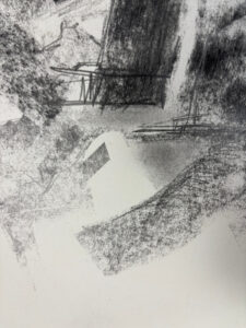 Detail image of an abstract charcoal and graphite drawing with powdery gray textures, sketch-like lines, and angular negative space on white paper.