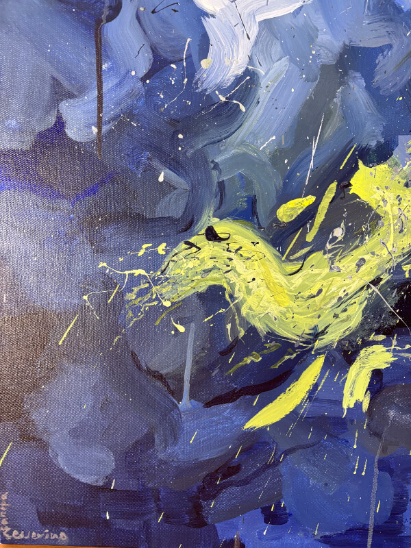 Close-up of an abstract acrylic painting with deep blue tones and a vivid yellow-green splash cutting across the canvas with drips and splatters.