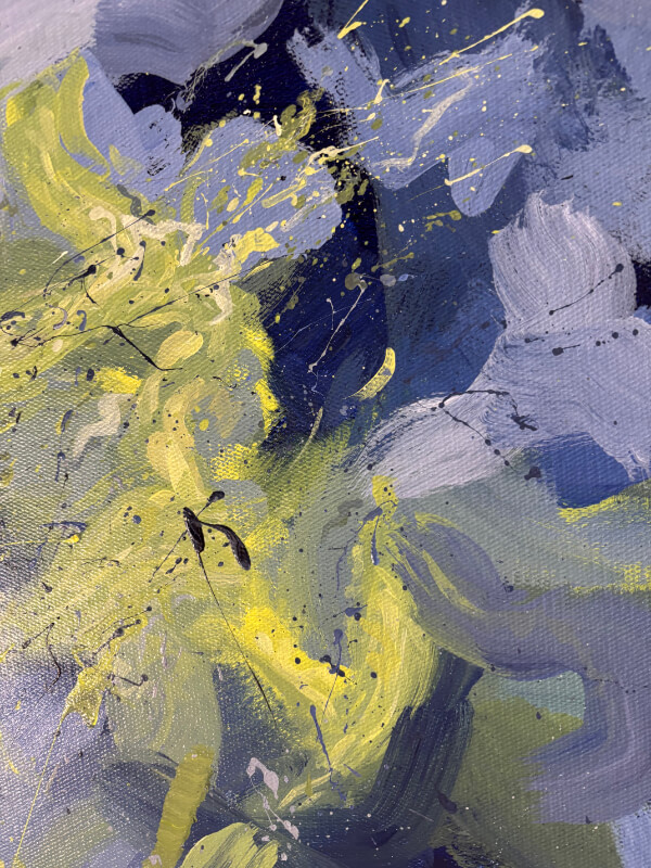Close-up of an abstract painting featuring luminous yellow-green brushwork layered over blue and grey strokes with fine splatter details.