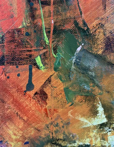 Macro view of olive green and orange palette knife scrapes and paint splatters on canvas texture.