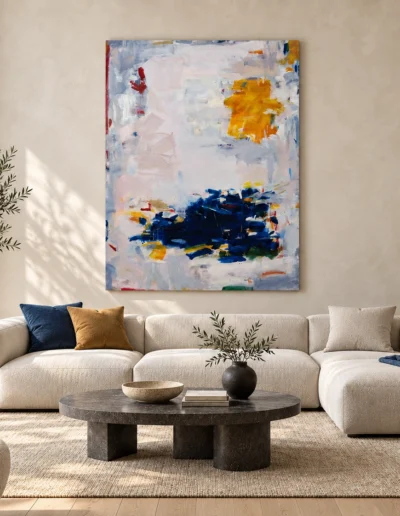 Living room mockup featuring Elevation of Two Silent States by Severino Canepa, a blue and orange abstract canvas displayed above an ivory sofa.